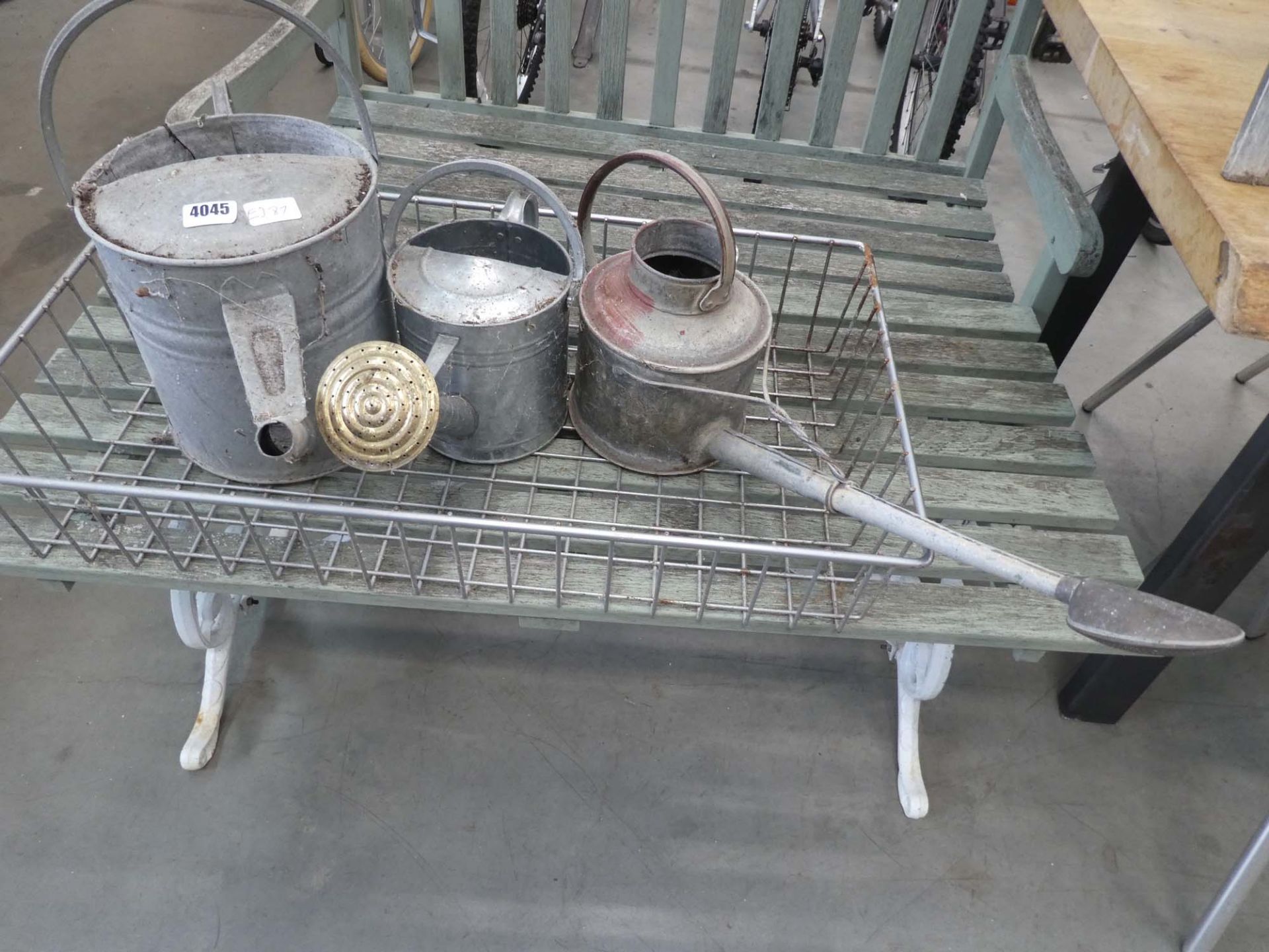 3 galvanized watering cans and galvanized tray