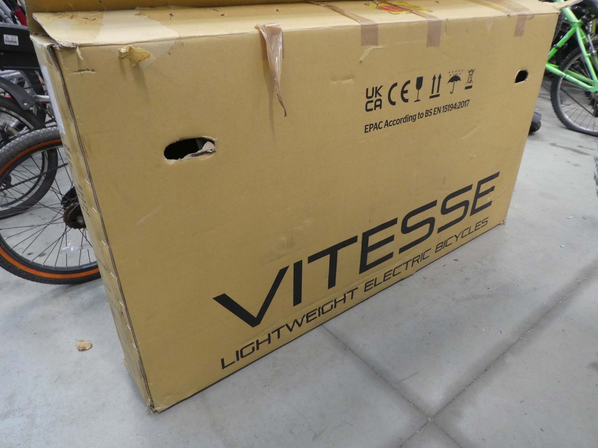 Boxed Vitesse electric bike in silver and black with power supply