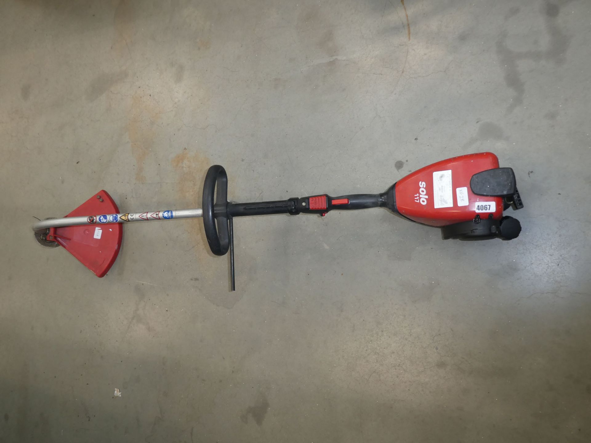 Solo red petrol powered strimmer