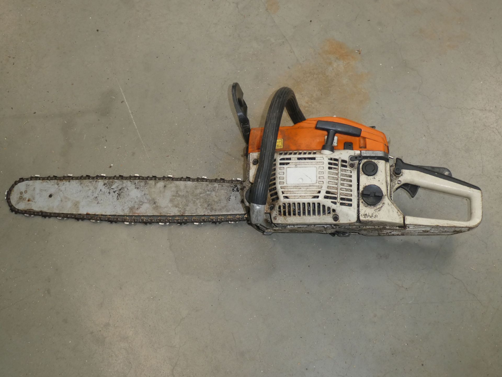 Orange petrol powered chainsaw