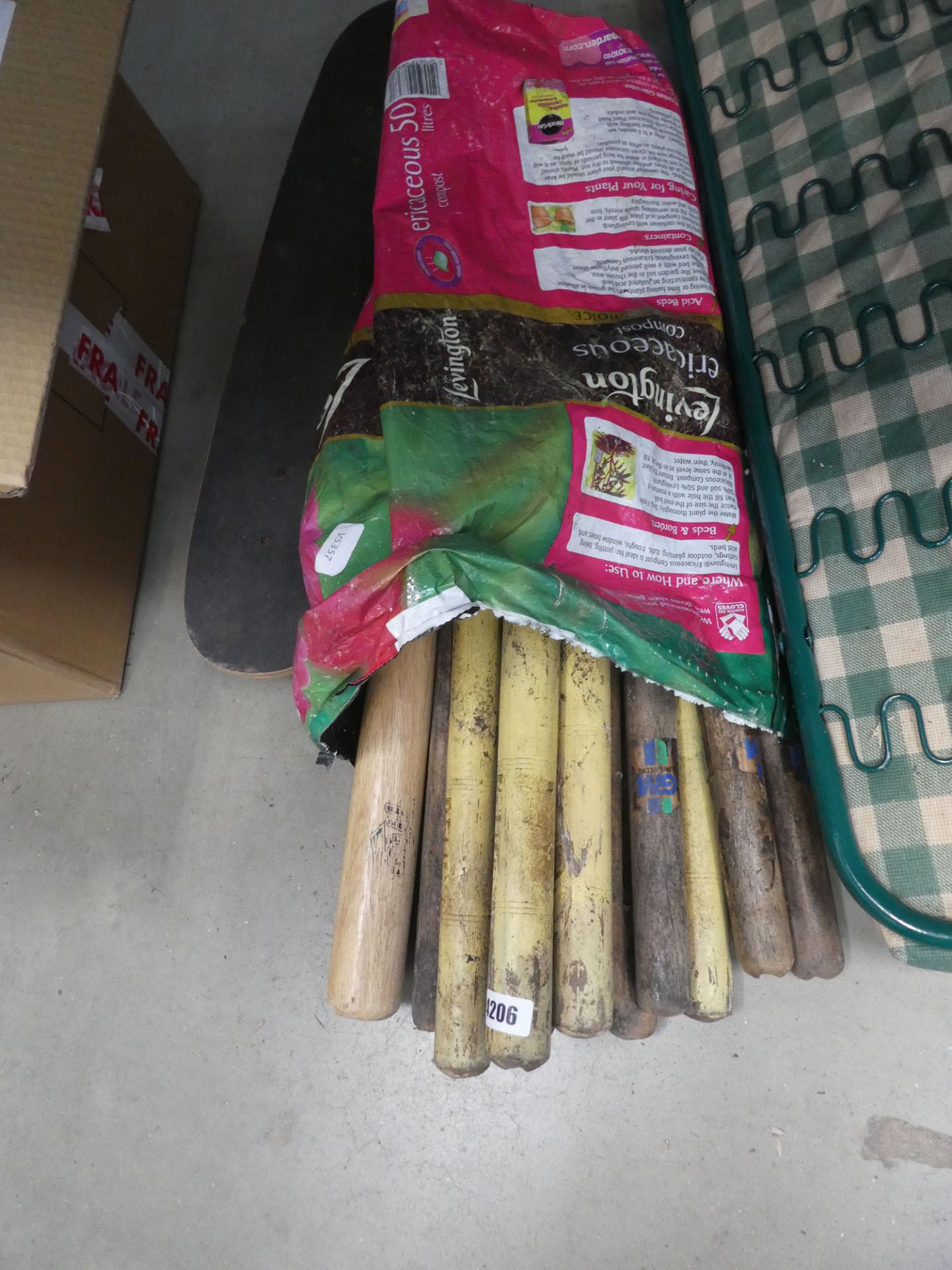 Quantity of cricket stumps, baseball bat and a skateboard