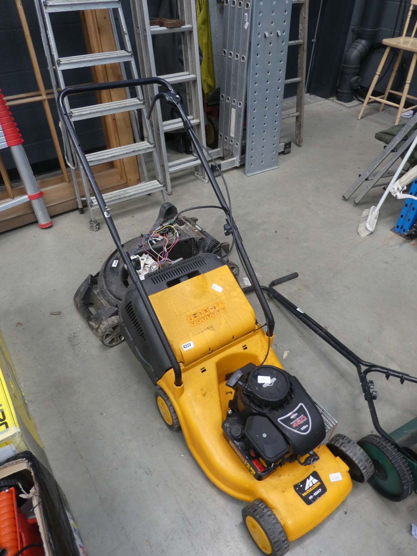 Yellow McCulloch petrol powered mower with grass box