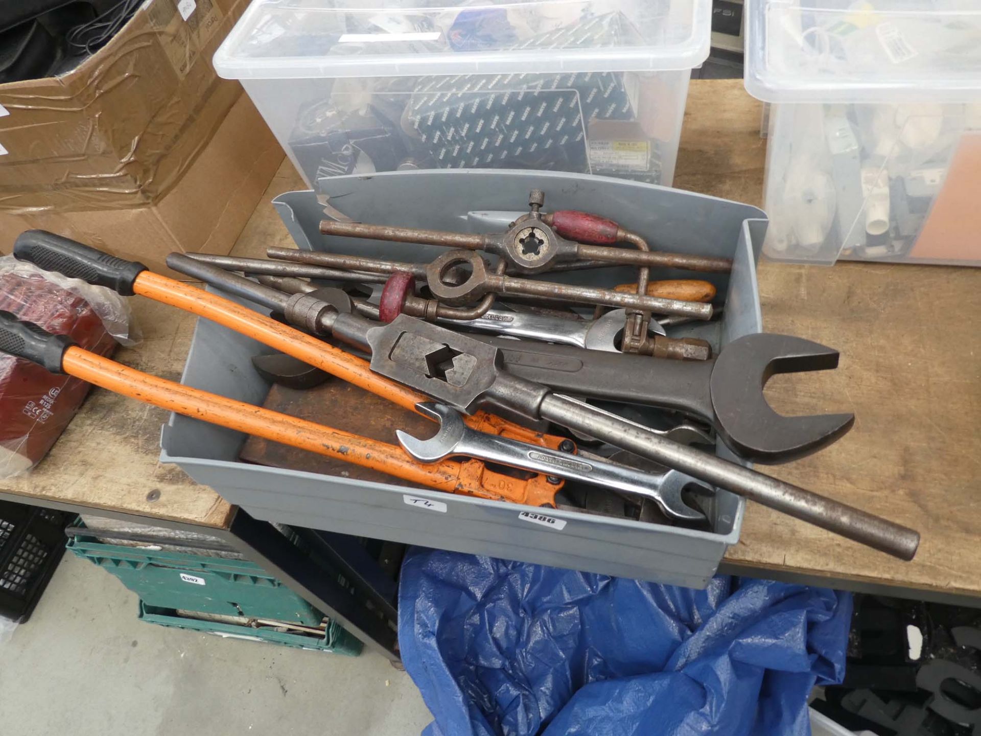 Plastic crate containing bolt croppers, spanners, taps, dies etc