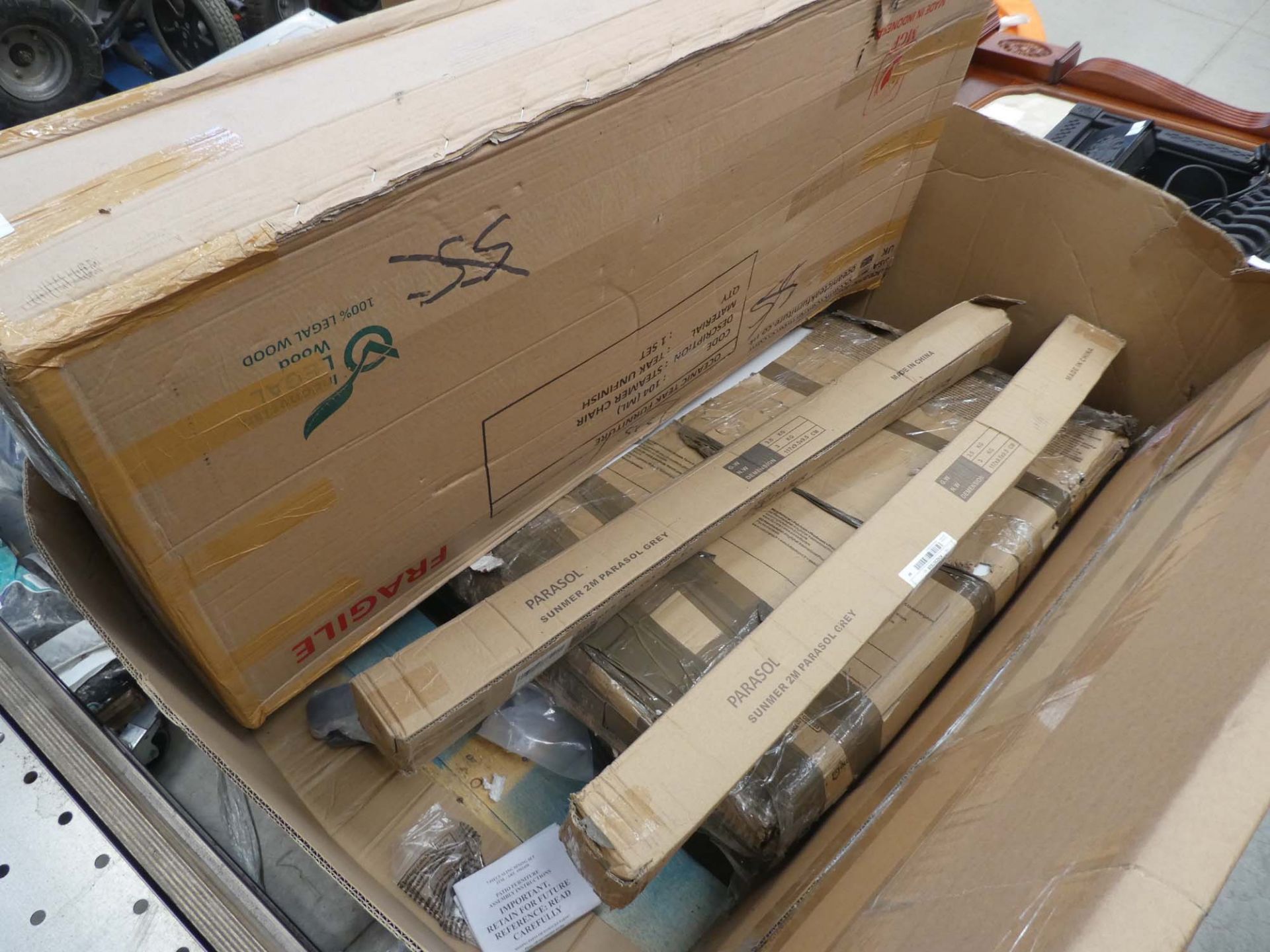 Pallet containing chair, parasols and other flat pack items