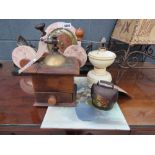 2 Coffee grinders, an ornamental cow bell plus a small oil on card still life with flowers