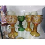 (2140RR) 358 - A set of four Bohemian amber glass drinking glasses of Renaissance design, h. 13.5