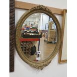Oval mirror in decorative gilt frame