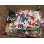 Box containing Lego dolls and toys