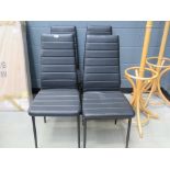 Four black leather effect dining chairs