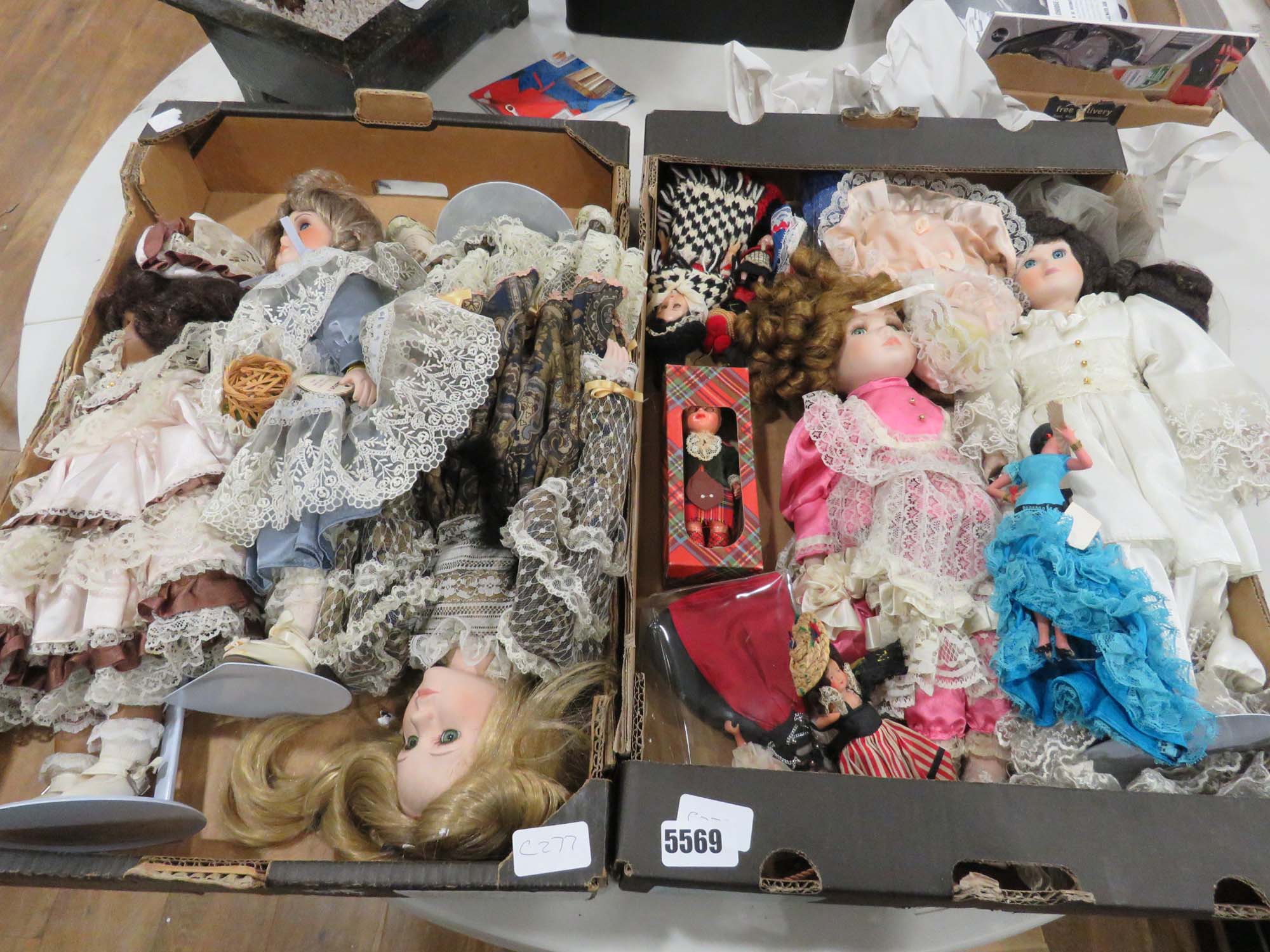 2 boxes containing porcelain dolls