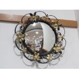 Convex mirror in black and gilt painted floral frame