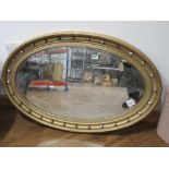 Oval bevelled mirror in gilt frame