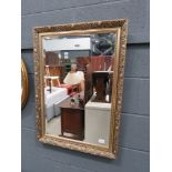 Rectangular bevelled mirror in decorative gilt frame