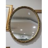 Oval mirror in decorative gilt frame