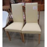 Pair of cream leather effect dining chairs