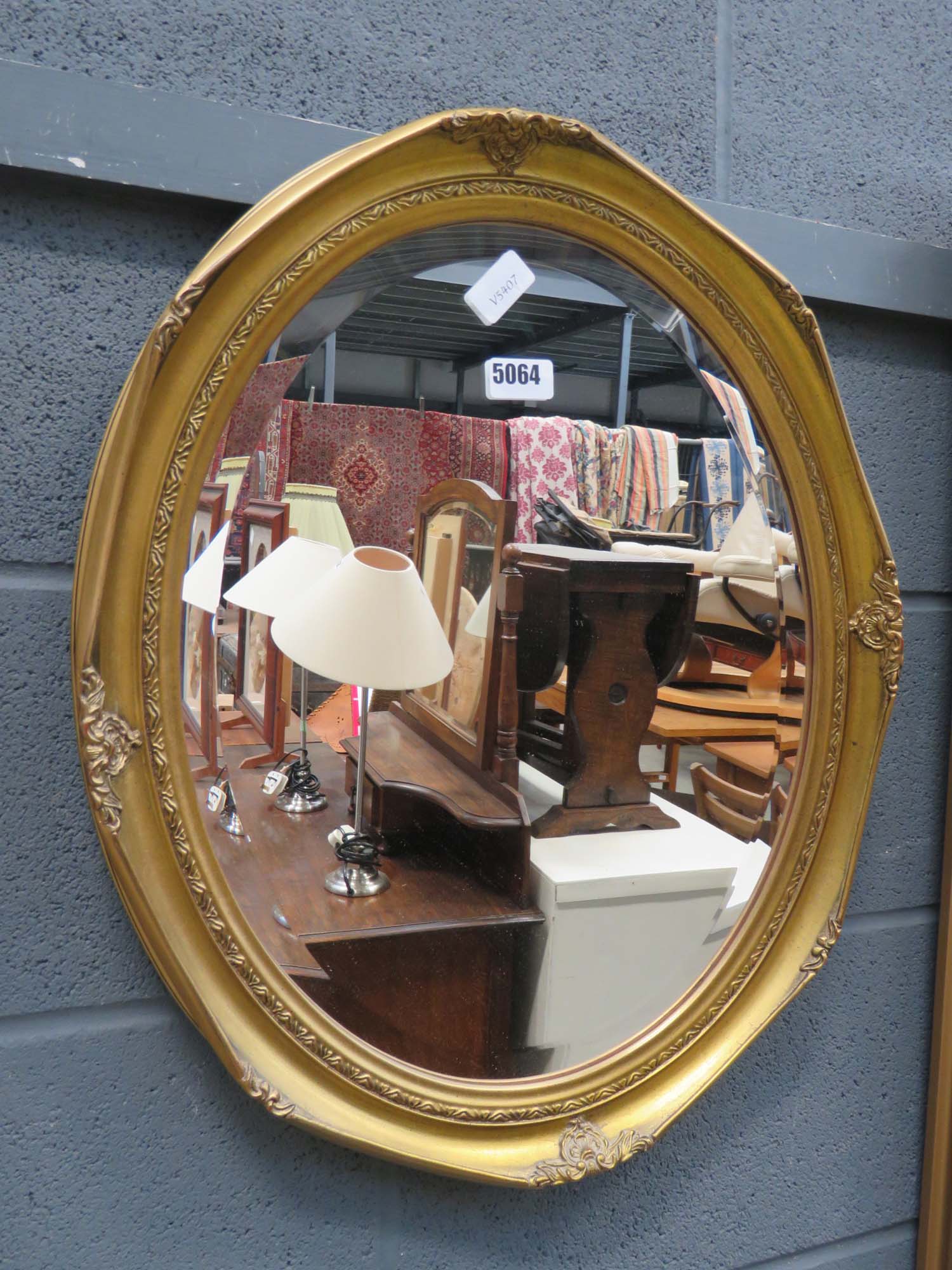 Oval bevelled mirror in gilt frame