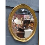 Oval bevelled mirror in gilt frame