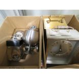 2 boxes containing carriage clocks and lighters