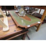 Reproduction mahogany coffee table with green leather surface