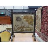 Carved wooden fire screen with embroidered dog panel