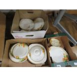 Three boxes containing floral patterned crockery