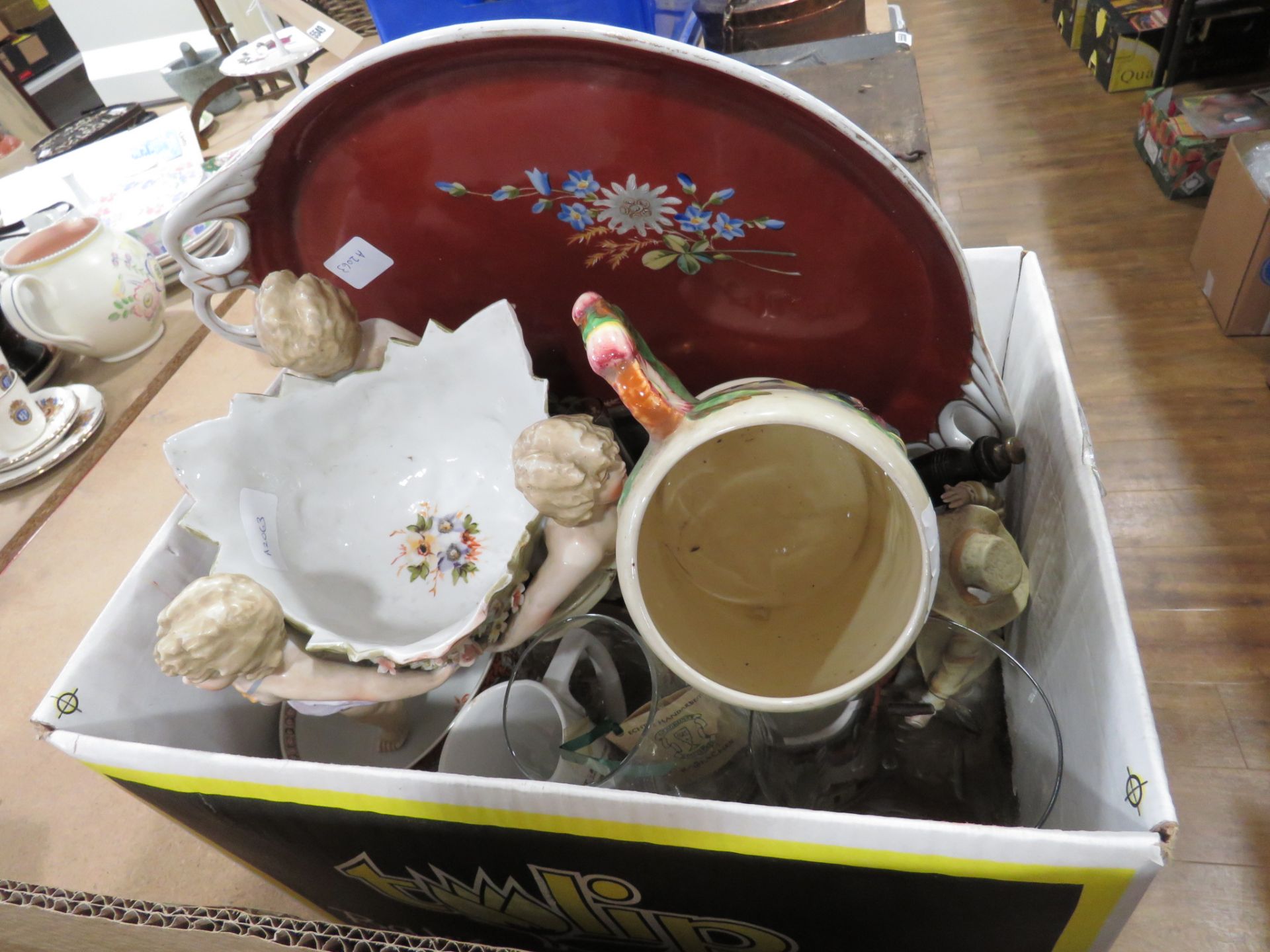 Box containing Oriental tray, pot with cherubs, musical jug, ornaments and Beatrix Potter crockery