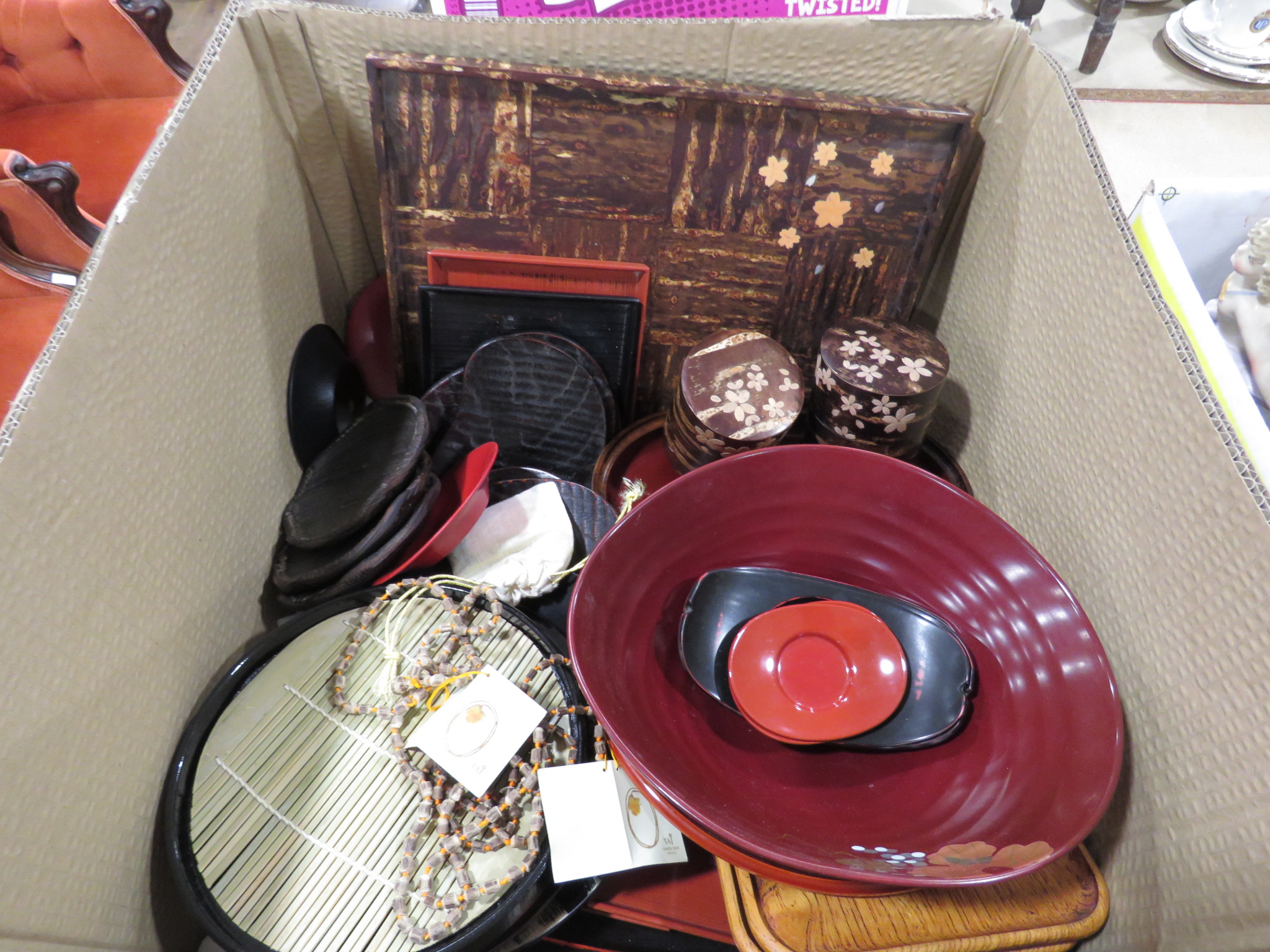 Box containing red and orange lacquered dishes plus storage pots and trays