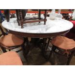 Carved dining table with circular marble surface