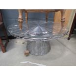 Circular glazed table with chromed wire base