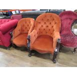 Pair of Victorian his and hers carved wooden armchairs in orange fabric