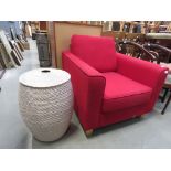 Red upholstered armchair together with a laundry basket