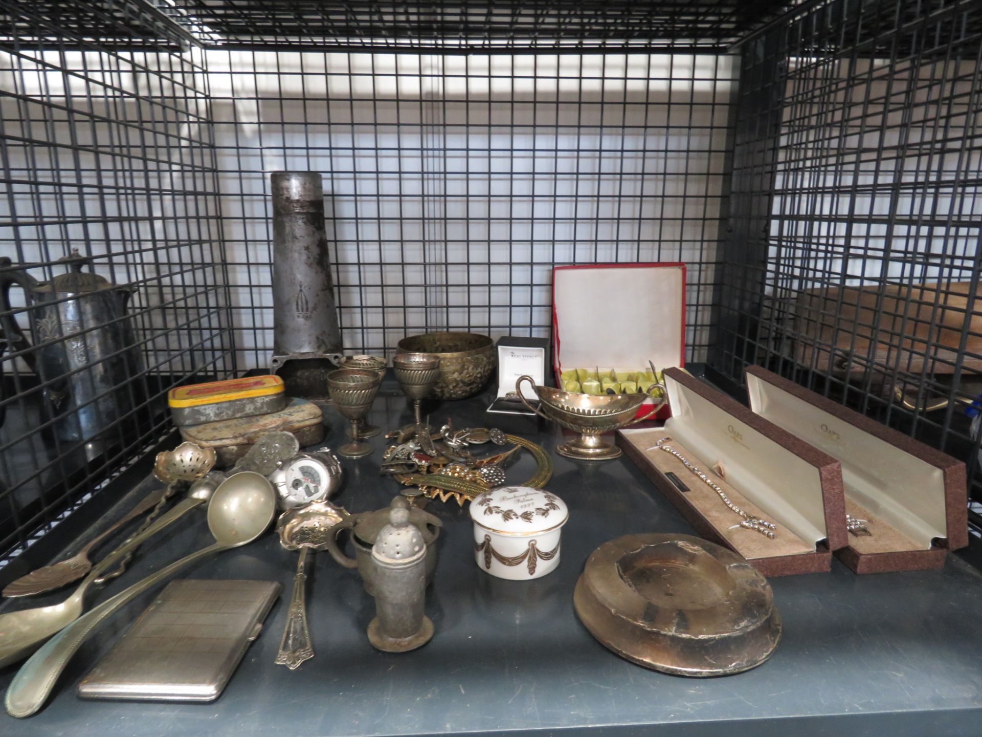 Cage containing a boxed teaspoon set, dress jewellery, loose cutlery, bracelets, egg cups and