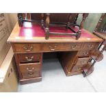 Walnut twin pedestal desk with red leather surface