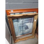 Gilt painted picture frame plus an urban print with stagecoach and building