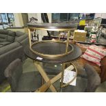 Circular coffee table on gold painted base with one nesting under