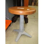Circular wooden stool on cast iron base