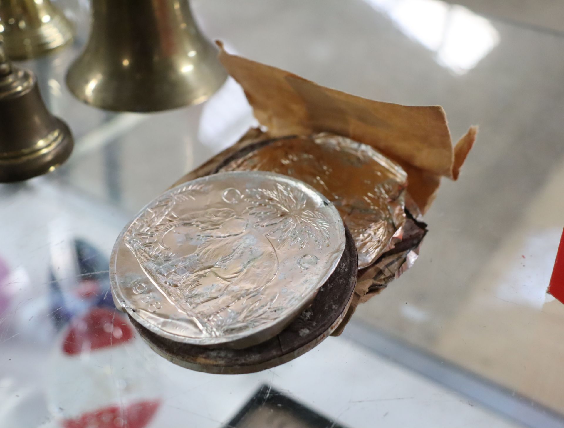 Aluminium foil covered chocolate coin, marked 1938 with similar coin in worse condition