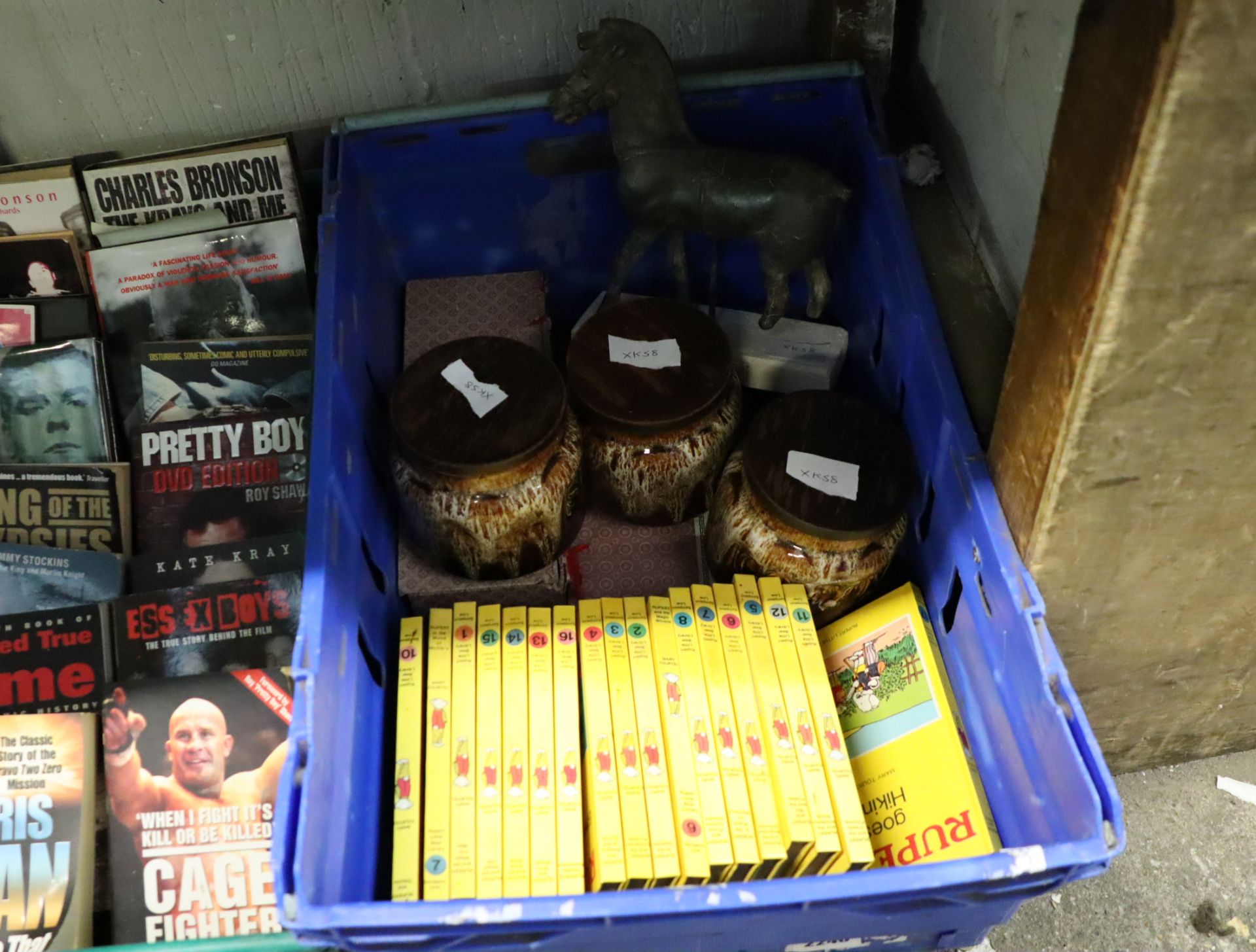 Crate containing Rupert childrens books, Fosters pottery tea, sugar and coffee set, brass horse,