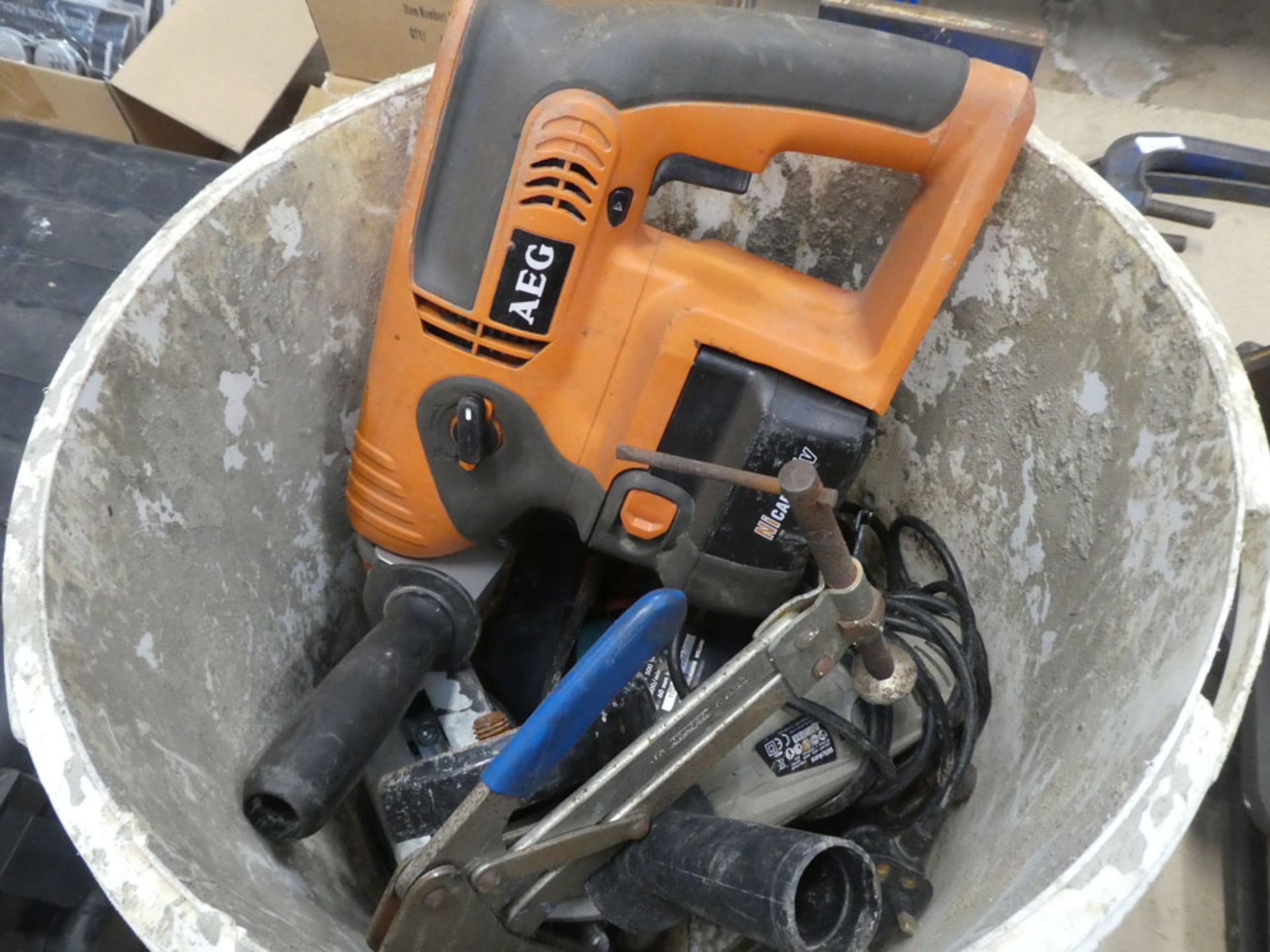 Black & Decker scorpion saw, a B&D drill and a bucket cont. AEG drill and various other tools