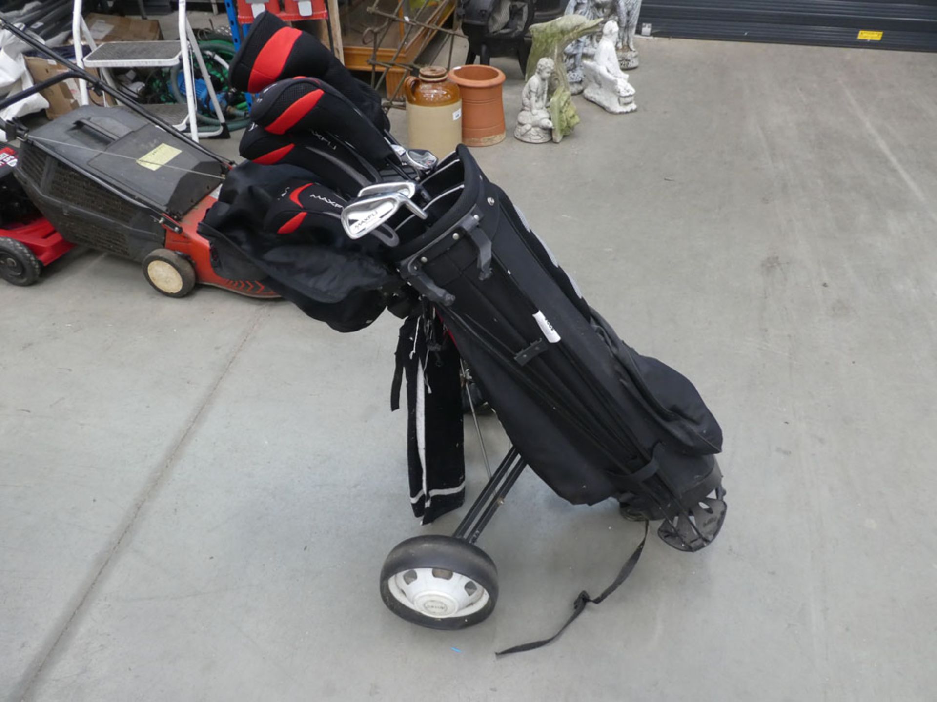 Red and black golf bag with quantity of Maxfli clubs