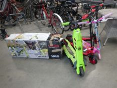 2 red, 1 green and 1 pink electric scooters