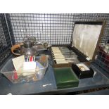 A cage containing a boxed fish knife and fork set, sugar nips, a bacon dish, a hot water jug,