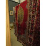 (4) Iranian carpet with green central medallion and maroon background