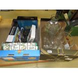 2 Boxes containing board games, books, placemats, glass dishes, vases and jugs