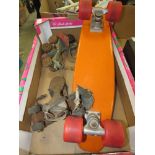 Box containing vintage rollerskates and a skateboard