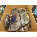 Box containing silver-plated plates and trays plus a brass trivet and a photo frame