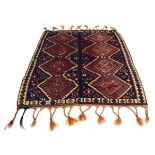 A Turkish kilim, constructed in two sections each with four medallians on a blue ground,