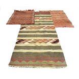 A Moroccan kilim, the red ground decorated with bands and zig zags, 144 x 85 cm,