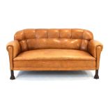 A late 19th century tan leather and button upholstered two-seater club sofa, North European,