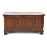 An 18th century oak coffer, the four panels strung with ebony decoration, with a vacant interior,